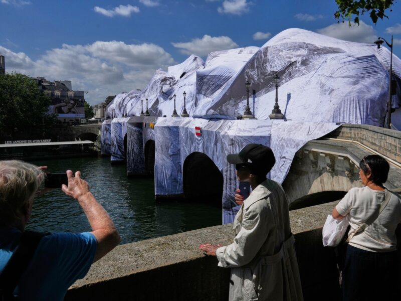 Artist JR, the 'French Banksy' creates a 'cave' installation over Paris' oldest bridge